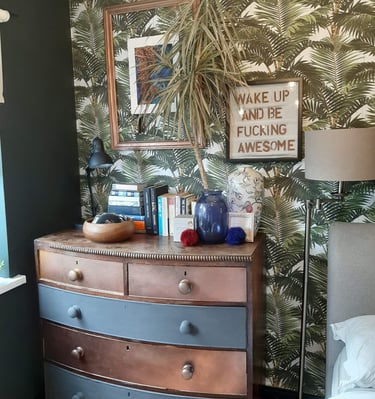 a dresser with wall art and accessories
