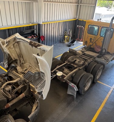 trucks to repair inside precision fleet garage
