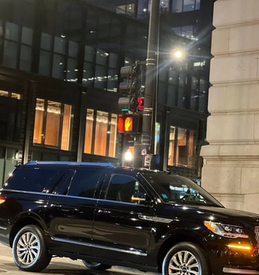 “Black Lincoln Navigator SUV providing Chicago black car service in downtown at night.”
