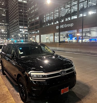 “Black Ford Expedition used for Chicago black car service parked downtown at night.”
