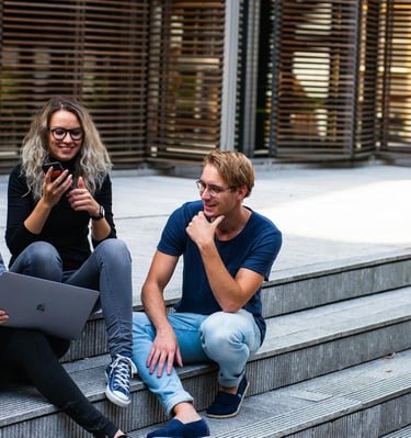 group of young millennials chatting in group on stairs representing gold ira for millennials