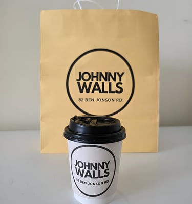 a coffee cup with a paper bag on it