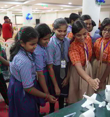 a group of people standing around a table with a cake