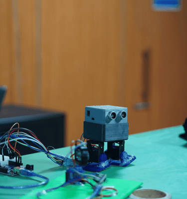 a robot robot with a laptop on a table