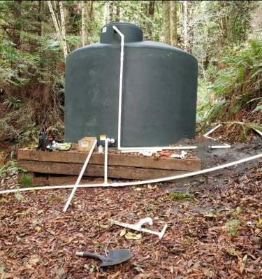 a repair of a tank of water in a wooded area