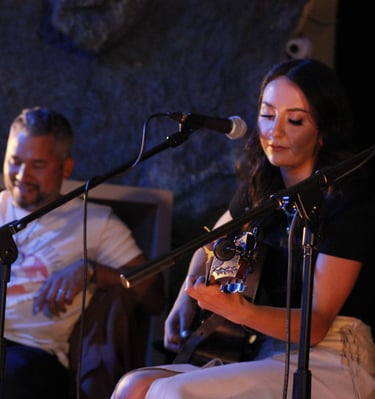 Emma Peterson performing beside Don Amero during an event in 2023