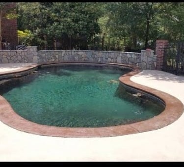a man cleaning a pool with a mop