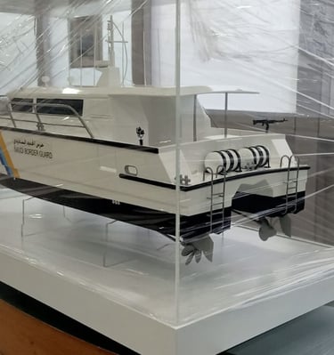 Scale model of a Saudi Border Guard patrol boat displayed in a protective glass case by Riviera.