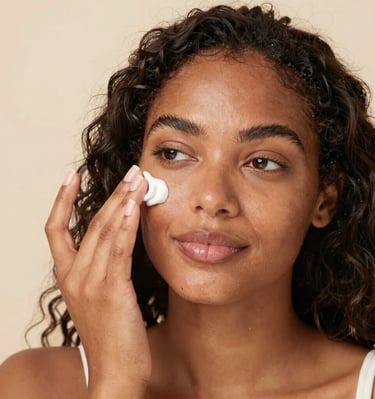 Close-up of a radiant face with natural makeup, highlighting smooth, glowing skin in soft golden hues.