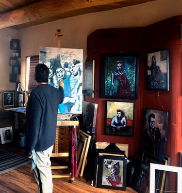 a man standing in front of a painting of a man