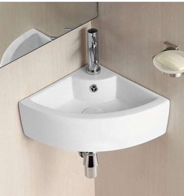 Small white ceramic corner wall-hung basin with chrome faucet and soap dish for compact bathrooms.