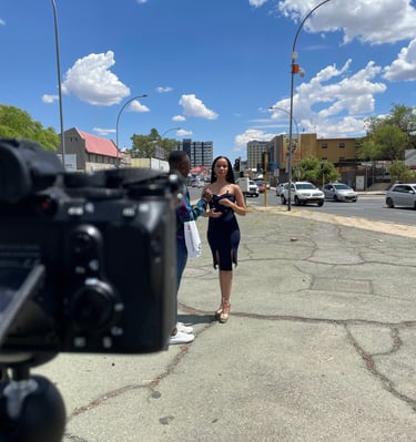 Shooting a video of a woman in a black dress