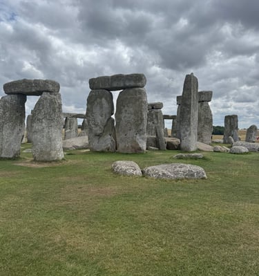 Ancient Stonehenge stone circle monument in England under a dramatic cloudy sky.