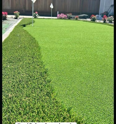 Artificial turf putting green installed in a residential backyard with golf flags, creating a relaxi