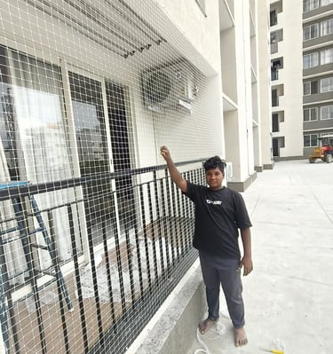 Professional installation team fixing heavy-duty balcony safety net at an apartment in Cuffe Parade,