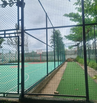 View of a vibrant football field enclosed by durable nets installed by Arjilli Safety Nets in Bengal
