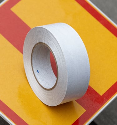 Rolls of reflective tape ready for application on road signs.