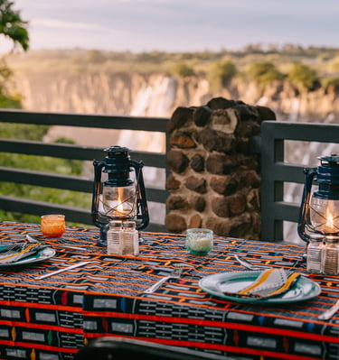 Guests enjoying authentic Zambian dining experiences at Moonbow Gatherings near Victoria Falls