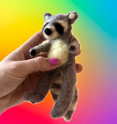 hand-felted raccoon sculpture made of raw fibers