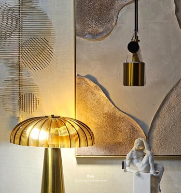 Modern luxury interior featuring a gold ribbed table lamp, white sculpture, and textured wall art.