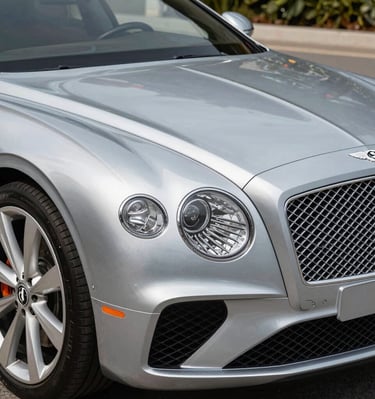 A luxury home exterior with a Blue Oyster Concierge vehicle parked, symbolizing attentive home watch services.