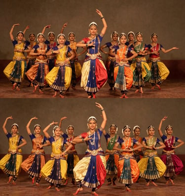 A group of female dancers performing the Kuchipudi Indian classical dance in traditional colorful silk costumes.