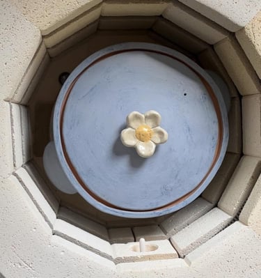 A handmade casserole pot inside a kiln