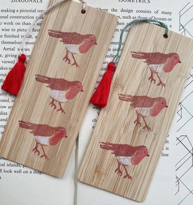 A pair of wooden bookmarks with handmade lino print of robins