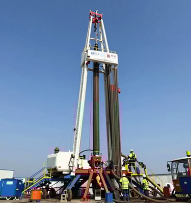 A sturdy drilling rig towering against a clear blue sky in an African oilfield.