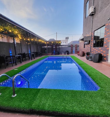 Inviting swimming pool area surrounded by greenery.