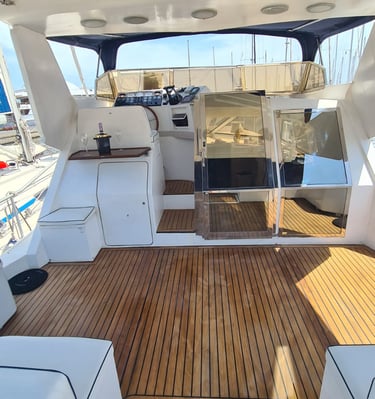 a boat with a wooden deck and a view of the ocean