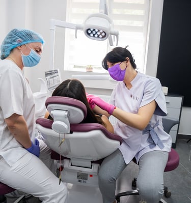 Dentist performing dental treatment on patient in modern Tbilisi clinic