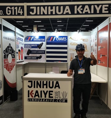 a man standing in front of a booth at a trade show
