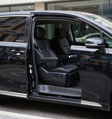 A smiling Chinese couple enjoying a comfortable ride inside a spacious vehicle with city views.
