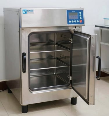 A healthcare professional holding a box of disposable gowns with a reassuring smile.