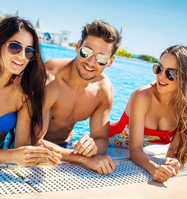 Group of friends relaxing by the pool at an exciting Las Vegas dayclub pool party, enjoying the sunshine in stylish swimwear