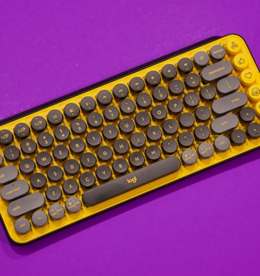 a keyboard and mouse mouse on a purple background
