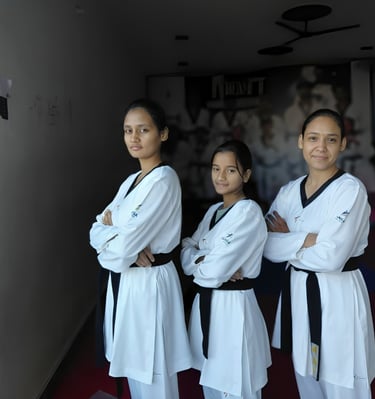 three women in white uniforms standing in a hallway