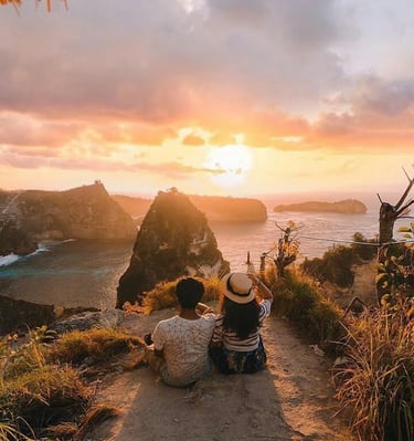 the sunsets in Nusa Penida are often experienced from high cliffs, providing a breathtaking, panoram