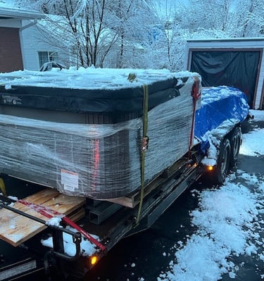 a hot tub on a trailer with lumber