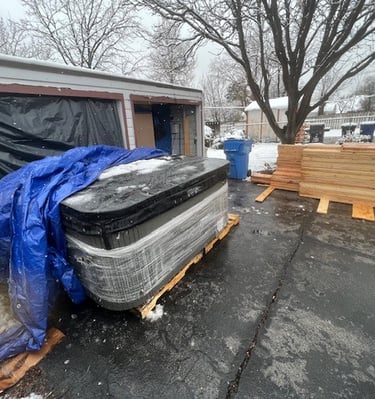 a hot tub in a driveway under a tarp