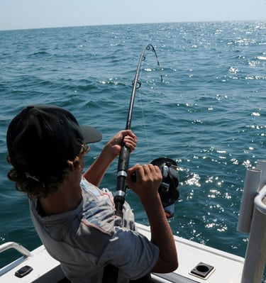 a man is fishing in the ocean with a fishing rod