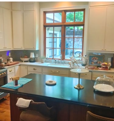 Modern kitchen with black granite island and window over sink