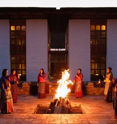 Bhutanese-women-performing-folk-songs-and-dances-during-cultural-show-over-firepit-at-amankora-Lodge
