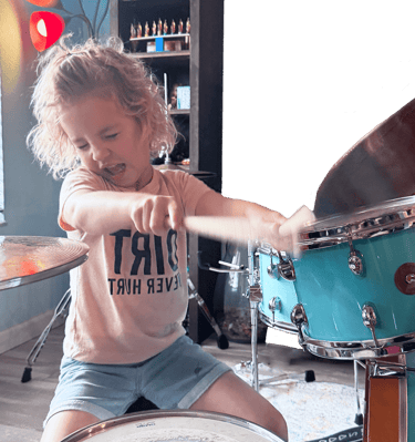 little girl playing blue drums