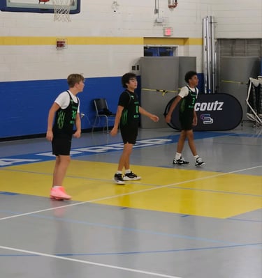 Wildcats playing basketball in a gym