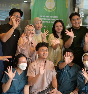 a group of people standing around a table with masks on