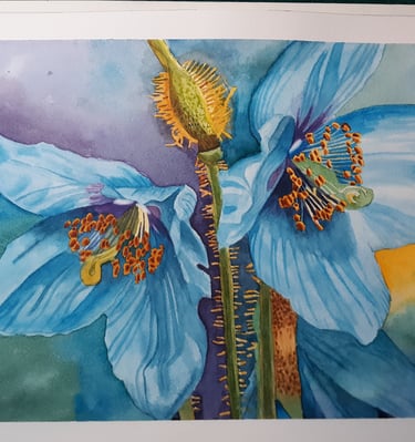 a watercolor painting of a blue hyacinth flower on a table with paintbrushes