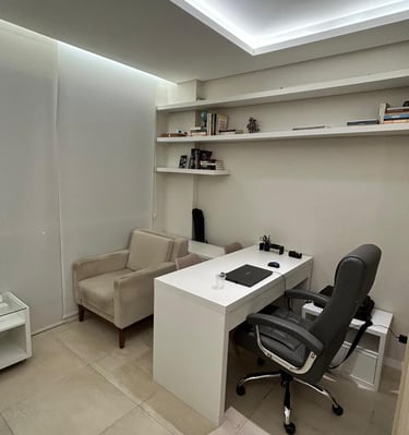 a desk with a chair and a chair in a room