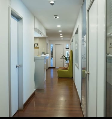 a hallway with a chair and a chair in the middle of the hallway